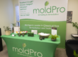MoldPro chemical-free remediation and testing information table with a branded banner and display materials.