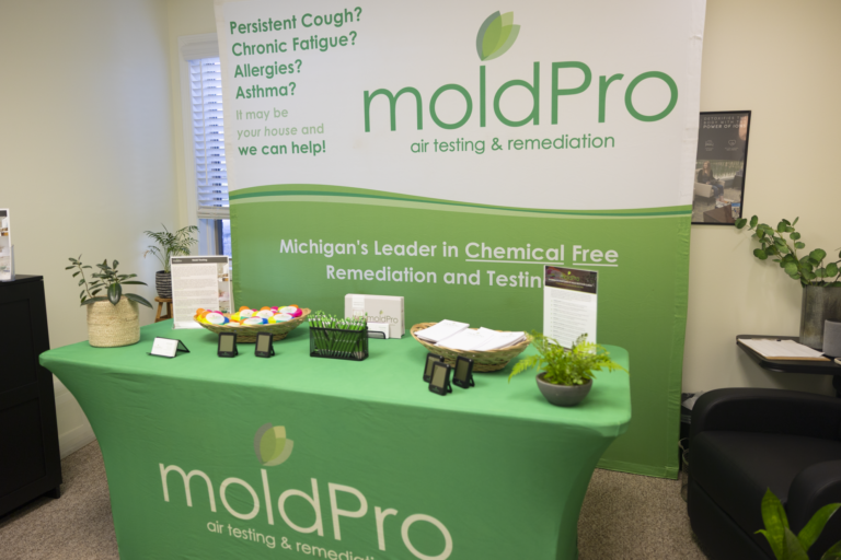 MoldPro chemical-free remediation and testing information table with a branded banner and display materials.