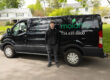 MoldPro technician standing beside the black MoldPro van, with the moldPro logo, phone number 734-439-8800, and inspection, testing, and remediation services listed on the side.