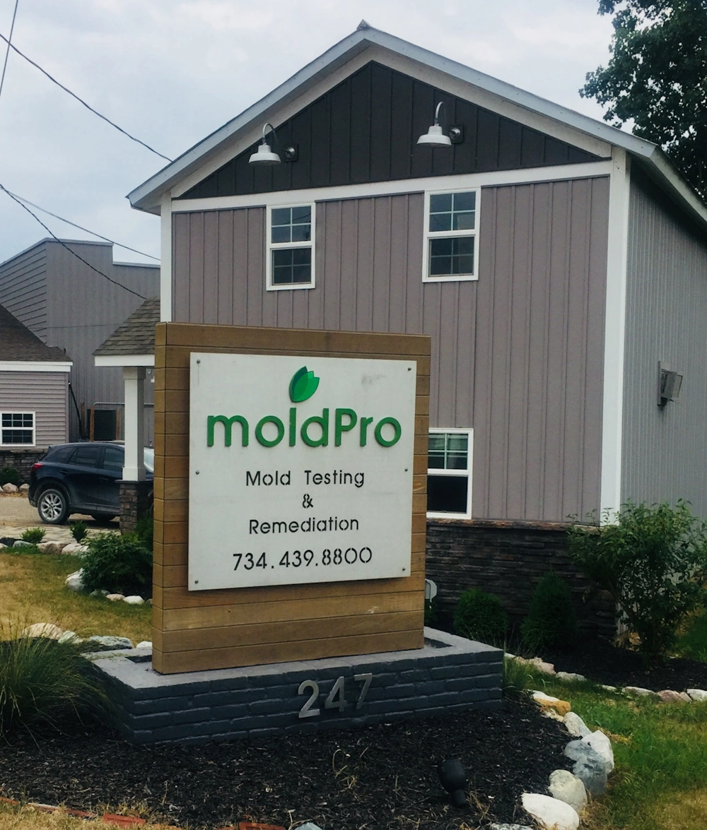 MoldPro owners at the door of their Milan, Michigan office